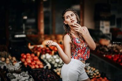 Portrait of a young woman standing at market