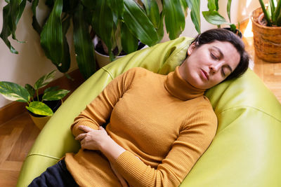 High angle view of woman lying at home