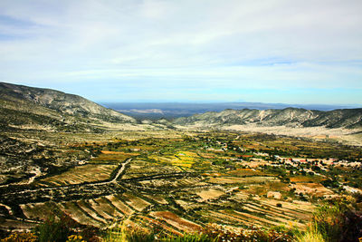 Aerial view of agricultural field against sky