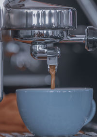 Close-up of pouring coffee in kitchen