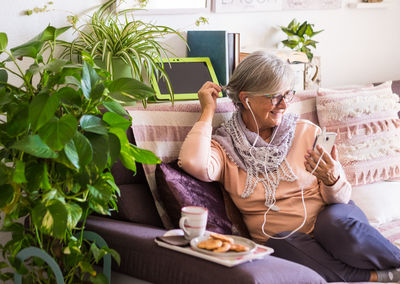 Midsection of woman sitting on sofa