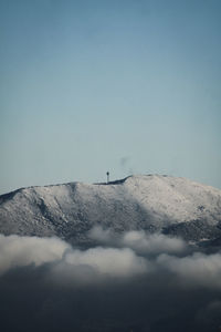 Low angle view of snowcapped mountain against clear sky