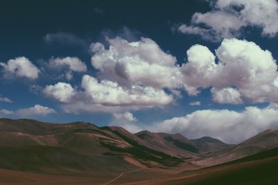 Scenic view of mountains against cloudy sky