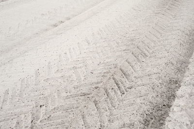 High angle view of footprints on sand