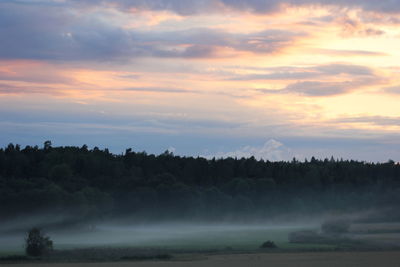Scenic view of landscape against cloudy sky