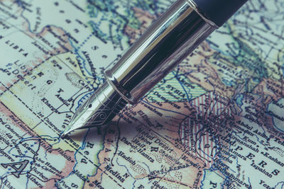 Close-up of fountain pen on map
