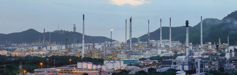 Panoramic view of industry against sky at dusk