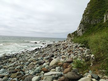 Rocks on beach against sky