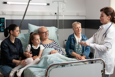 Doctor talking with patient and family