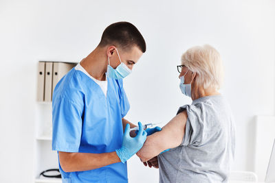 Side view of couple standing against white background