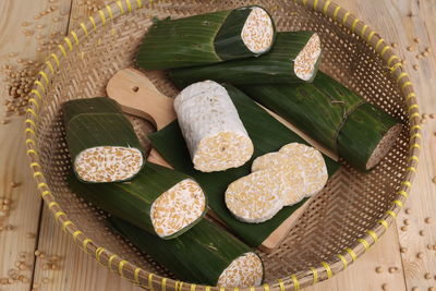 Close-up of food wrapped in banana leaves on wooden table