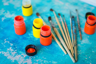 Close-up of multi colored bottles on table