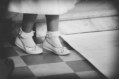 Low section of girl standing on floor