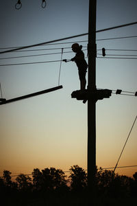 Low angle view of silhouette man against orange sky