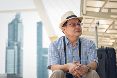 Low angle view of man holding camera