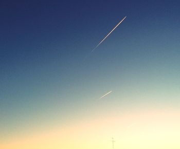 Low angle view of vapor trail against clear blue sky