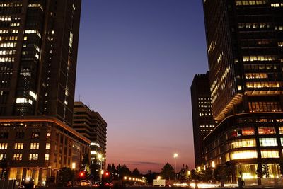 Road amidst modern buildings against sky