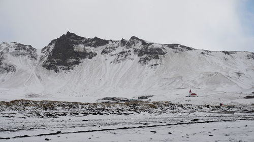 Scenic view of snow covered mountains against sky