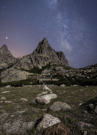 Scenic view of rocks at night against sky