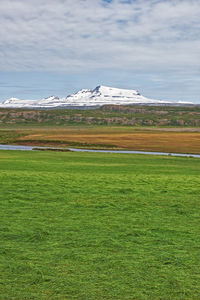 Scenic view of field against sky during winter