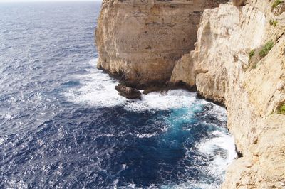 View of rocky cliff by sea