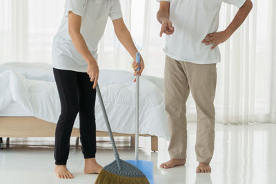 Low section of people standing at home