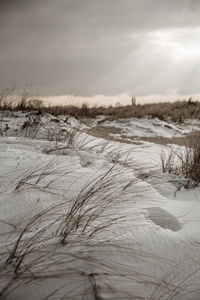 Scenic view of snow covered land against sky