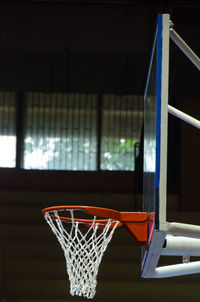 Close-up of basketball hoop against window