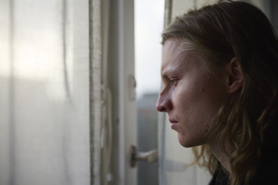 View of woman looking through window