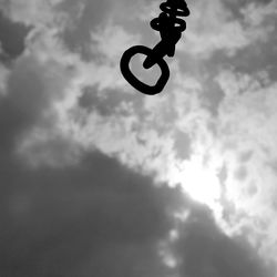 Low angle view of person paragliding against sky