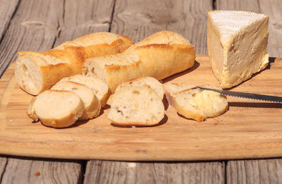 Close-up of cheese on bread at cutting board