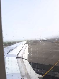 Close-up of airplane wing against clear sky