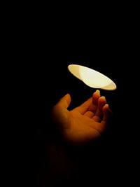 Close-up of hand holding illuminated lamp