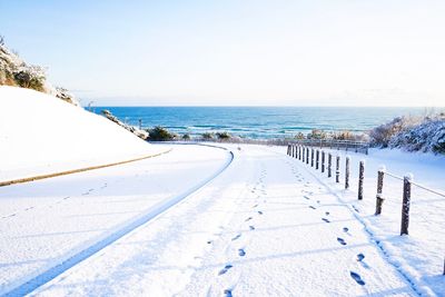 Scenic view of sea against clear sky during winter