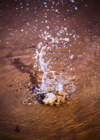 Reflection of man in water splashing