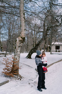 Full length of boy walking on snow