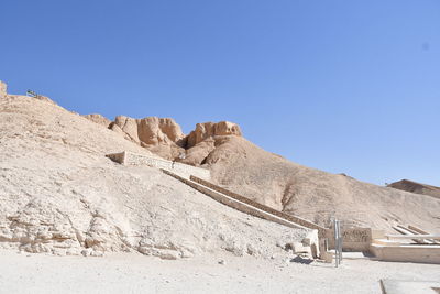 Scenic view of desert against clear blue sky