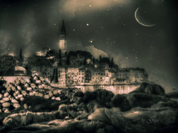 Digital composite image of buildings in city at night