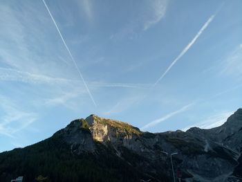 Scenic view of vapor trails against blue sky