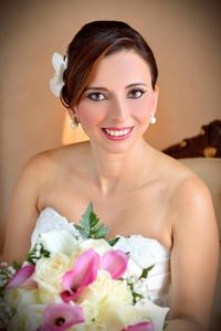 Portrait of beautiful young bride holding flower bouquet