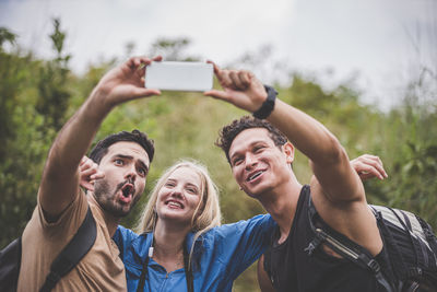 Portrait of smiling young woman using mobile phone