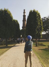 Rear view of man looking at the qutub minar