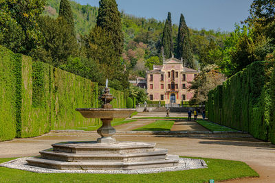 Fountain in garden against building