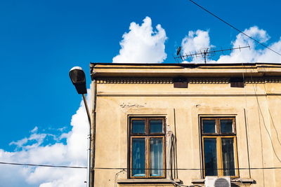 Low angle view of building against blue sky