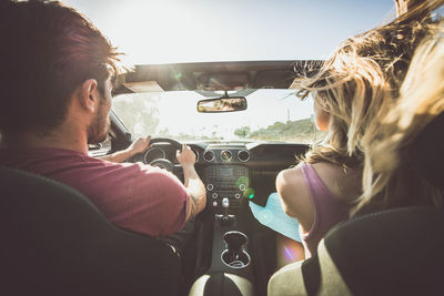 Rear view of man and woman in car