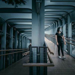 Woman standing on bridge