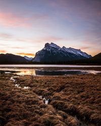 Scenic view of lake against cloudy sky