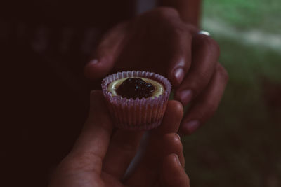 Cropped hands holding sweet food