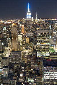 Aerial view of illuminated buildings in city at night