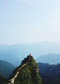 Man standing on mountain against sky